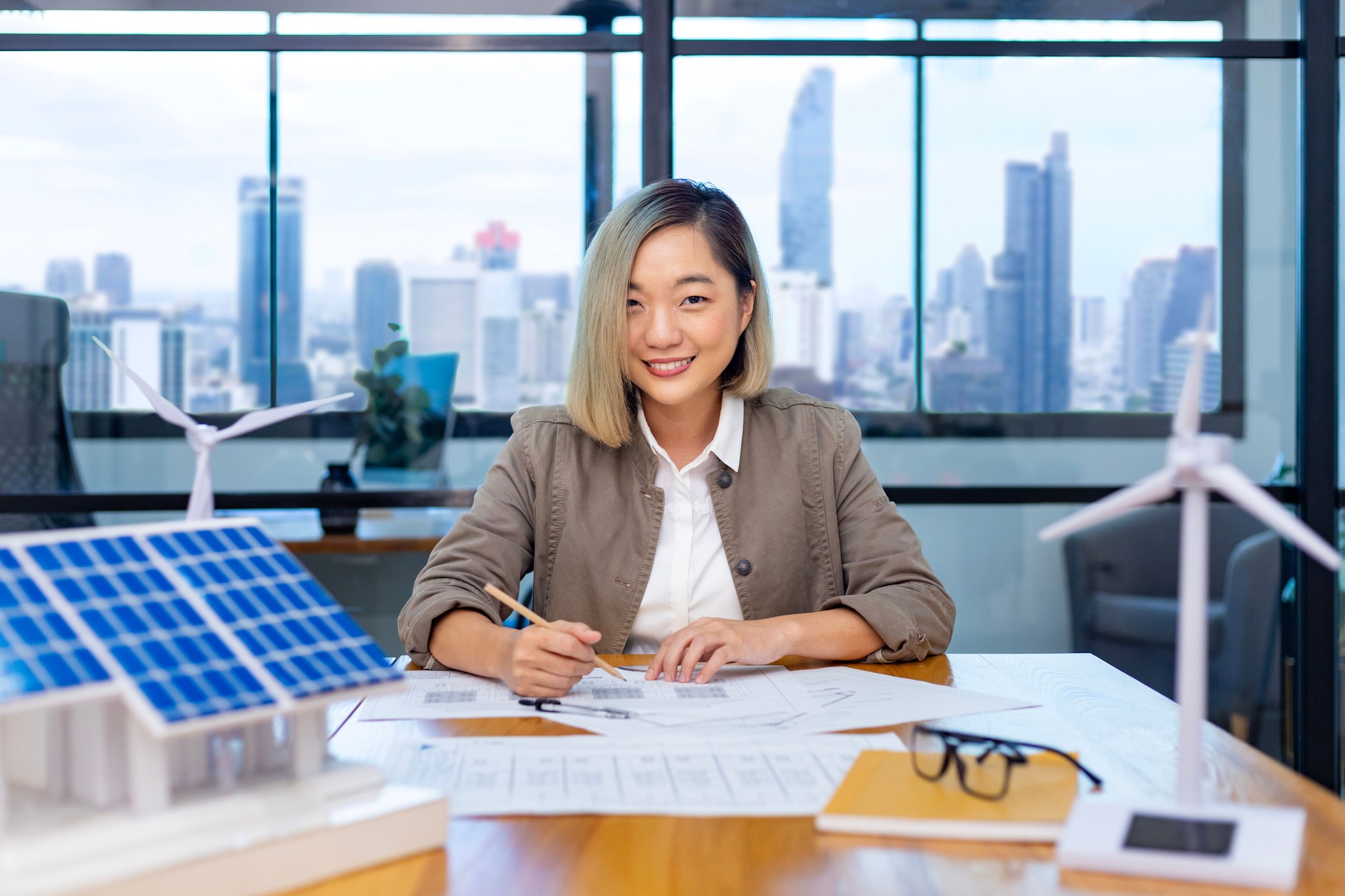Architect planning in innovative sustainability power design on housing development project with wind turbine generator and solar panel for renewable energy business and zero waste industry